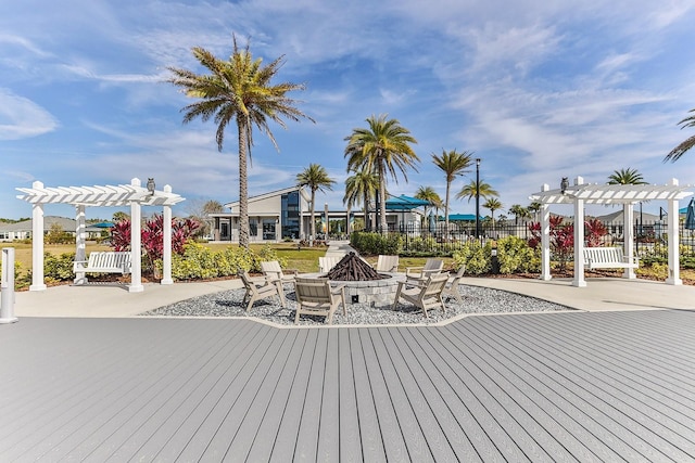 deck with a pergola, a patio area, and a fire pit