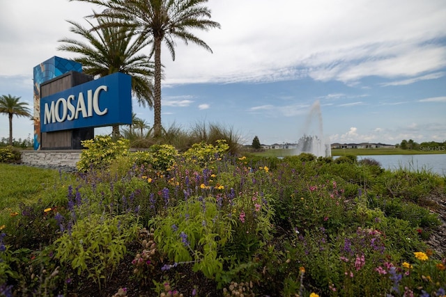 community / neighborhood sign with a water view