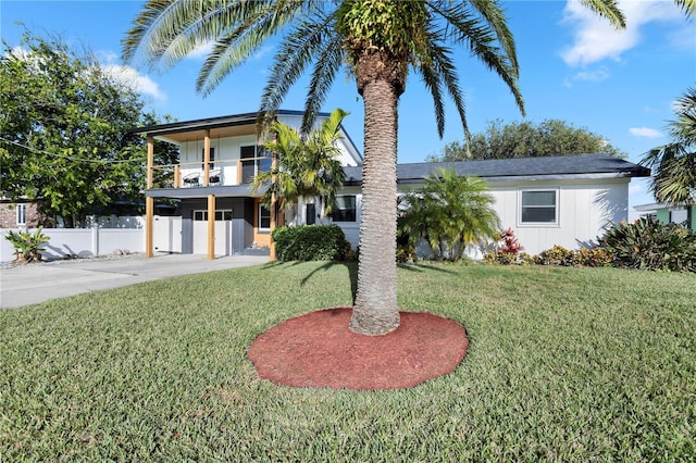 view of front of property with a balcony and a front yard