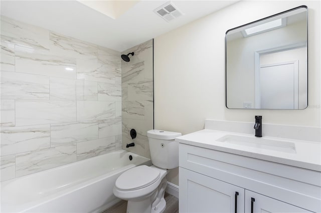 full bathroom with tiled shower / bath combo, toilet, and vanity