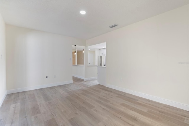 empty room with light hardwood / wood-style floors