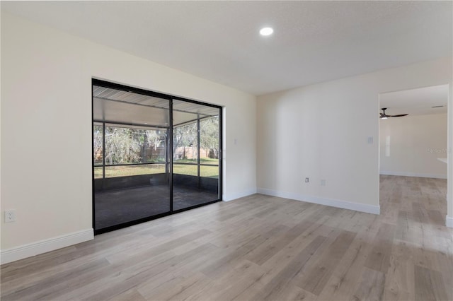 spare room featuring light hardwood / wood-style flooring and ceiling fan