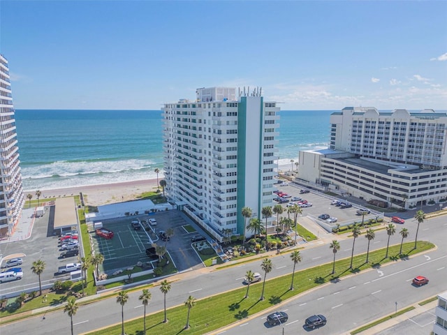 birds eye view of property with a view of the beach and a water view