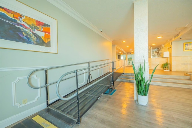 staircase featuring crown molding, recessed lighting, and wood finished floors