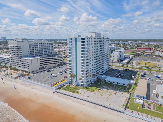 birds eye view of property featuring a city view, a view of the beach, and a water view