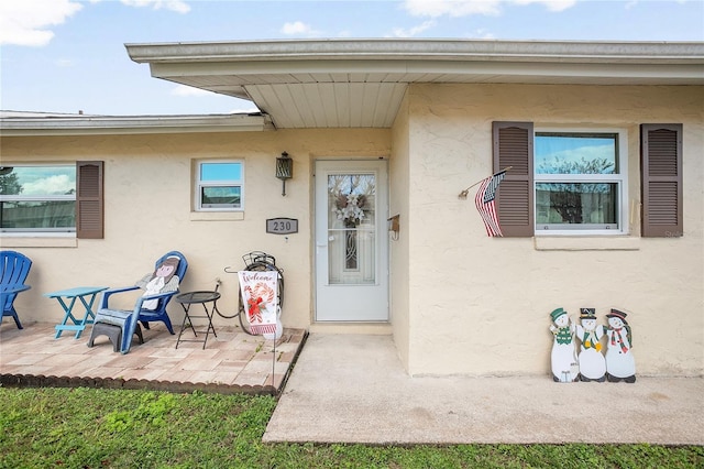 entrance to property with a patio