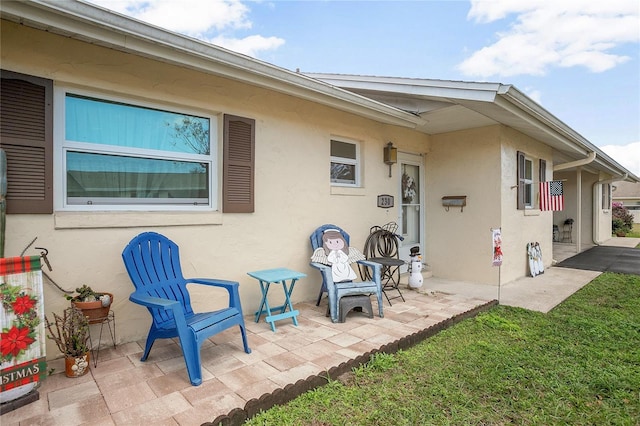 rear view of house with a patio area and a lawn