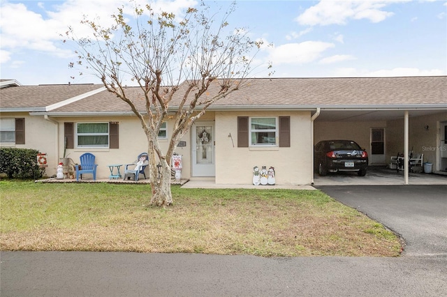 ranch-style house with a front lawn and a carport