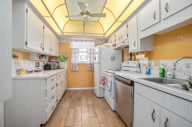 kitchen with white cabinetry, dishwasher, sink, light hardwood / wood-style flooring, and range