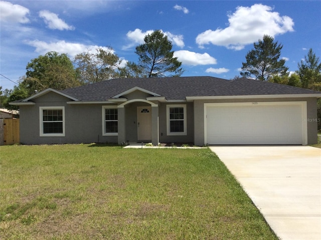 single story home featuring a garage and a front yard