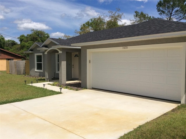 ranch-style home with a front lawn and a garage