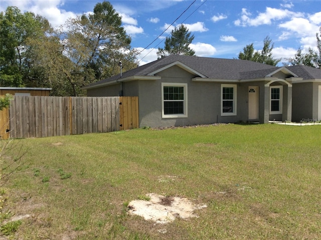 ranch-style home featuring a front yard