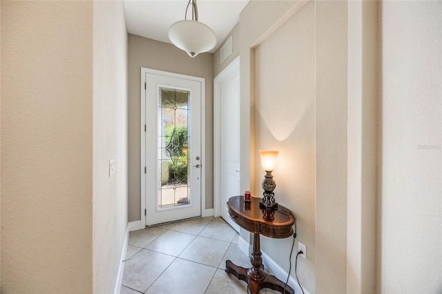 entryway with light tile patterned floors