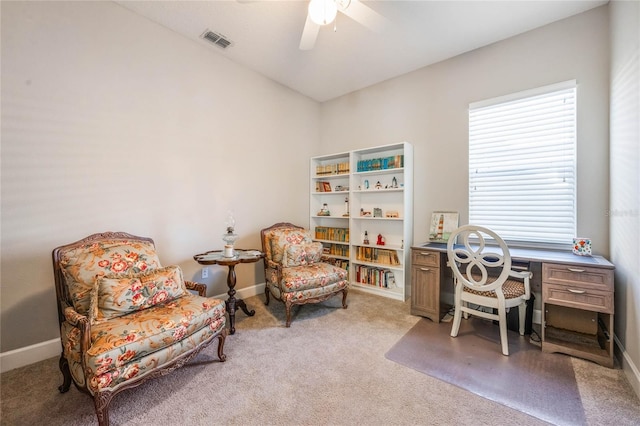 office space featuring ceiling fan and light carpet