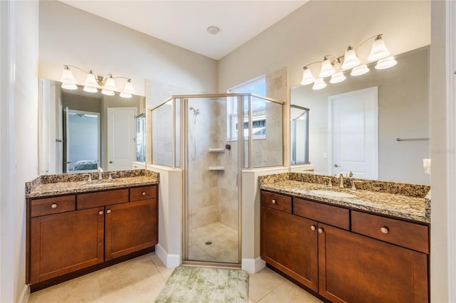 bathroom featuring tile patterned flooring, vanity, and walk in shower