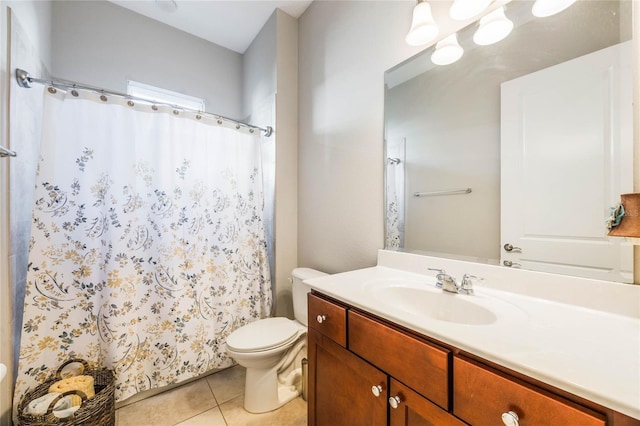 bathroom with tile patterned floors, curtained shower, vanity, and toilet