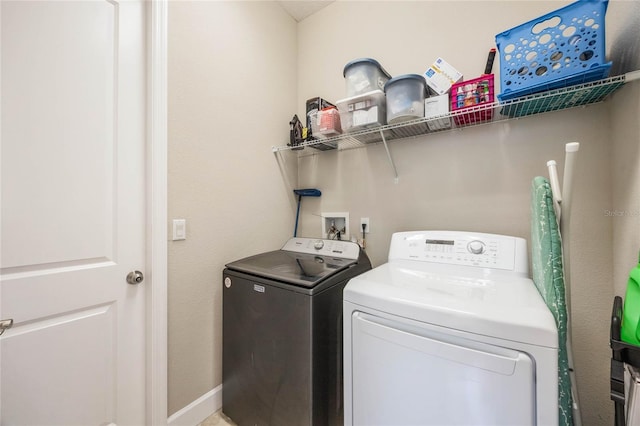 clothes washing area featuring independent washer and dryer