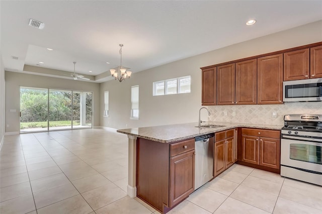 430 Cypress Hills Way, Deland, FL 32724 - kitchen featuring stainless steel appliances, a sink, decorative backsplash, a chandelier, and open floor plan
