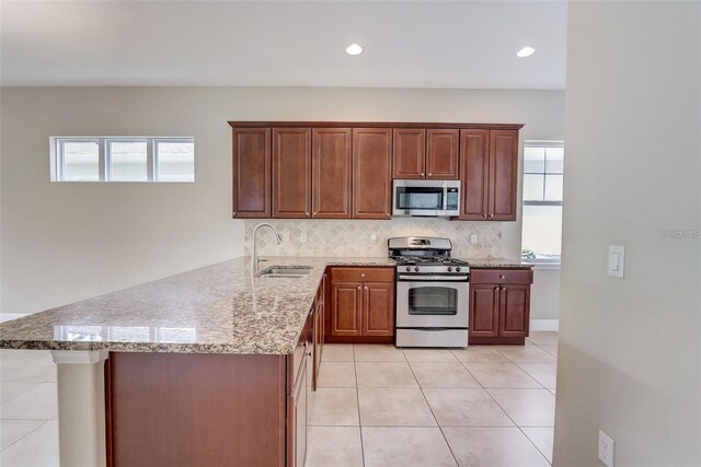 430 Cypress Hills Way, Deland, FL 32724 - kitchen featuring stainless steel appliances, a sink, healthy amount of natural light, tasteful backsplash, and recessed lighting