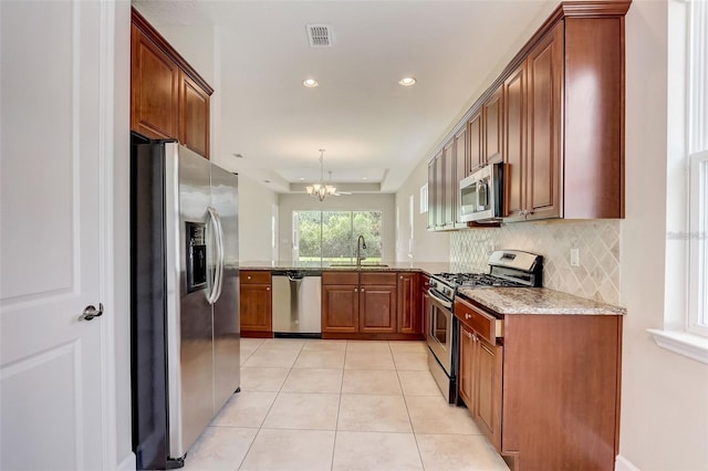 430 Cypress Hills Way, Deland, FL 32724 - kitchen with stainless steel appliances, a sink, light tile patterned flooring, decorative backsplash, and recessed lighting