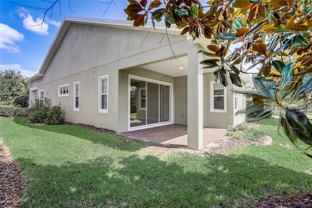 430 Cypress Hills Way, Deland, FL 32724 - rear view of house featuring stucco siding, a patio area, and a yard