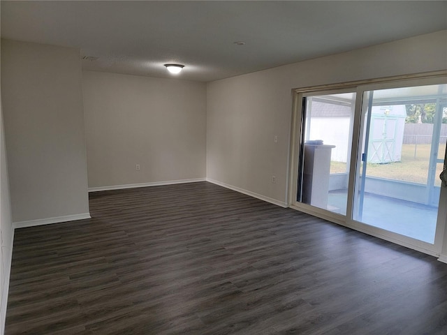 unfurnished room with a textured ceiling and dark wood-type flooring