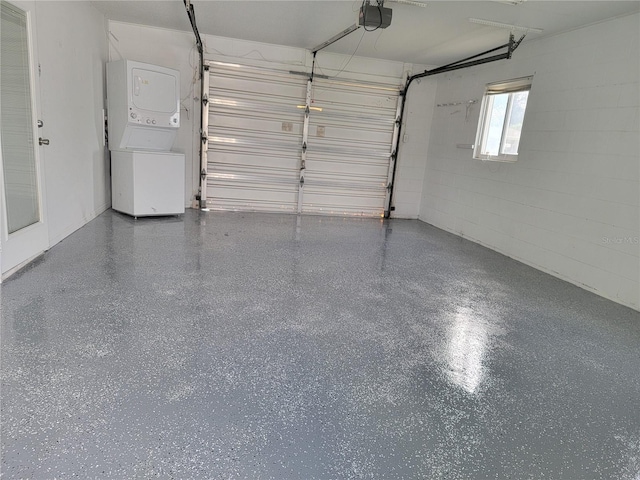 garage featuring a garage door opener and stacked washer and clothes dryer