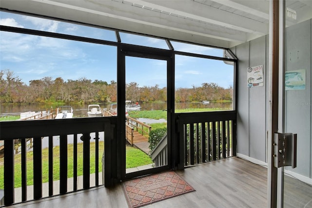 doorway featuring a water view and hardwood / wood-style flooring