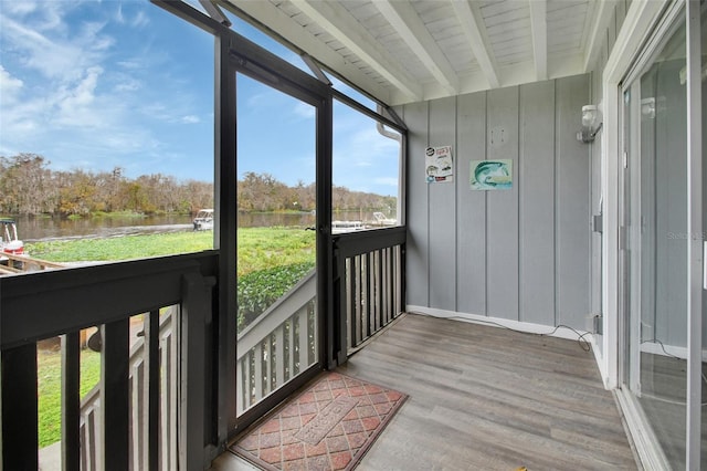 sunroom featuring a water view, beamed ceiling, and wood ceiling