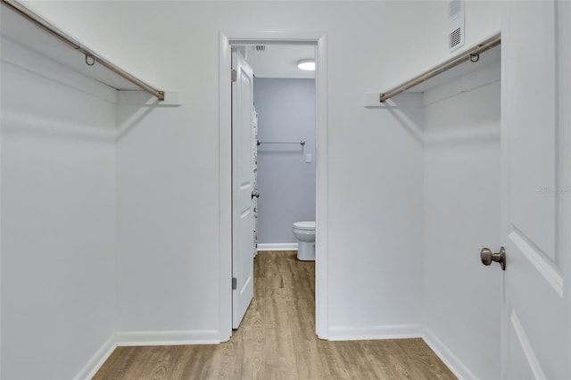 spacious closet with light hardwood / wood-style floors