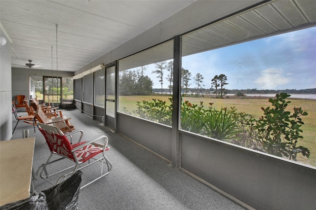 sunroom / solarium featuring ceiling fan and a rural view