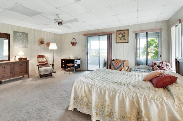 bedroom with ceiling fan, carpet, a paneled ceiling, and access to outside