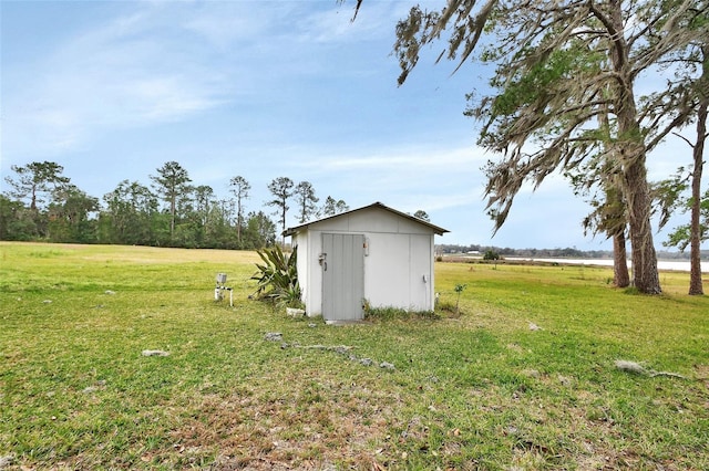 view of outbuilding featuring a lawn and a rural view