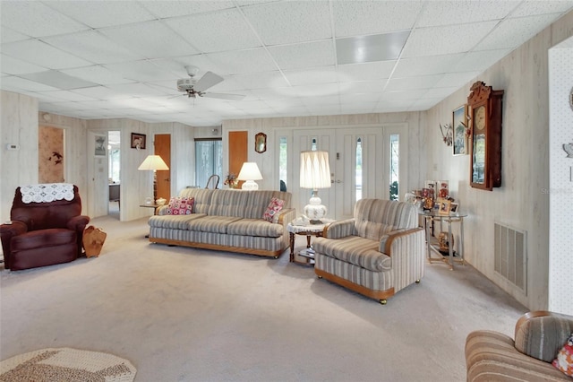 living room with ceiling fan, carpet, and a paneled ceiling