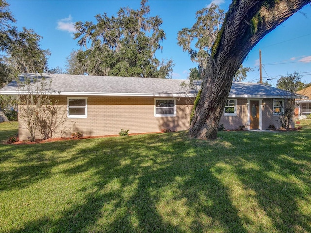 rear view of property featuring a yard