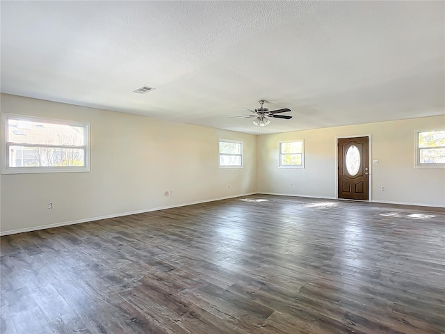 interior space with ceiling fan and dark wood-type flooring