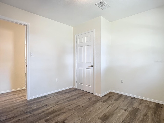 spare room featuring dark hardwood / wood-style floors