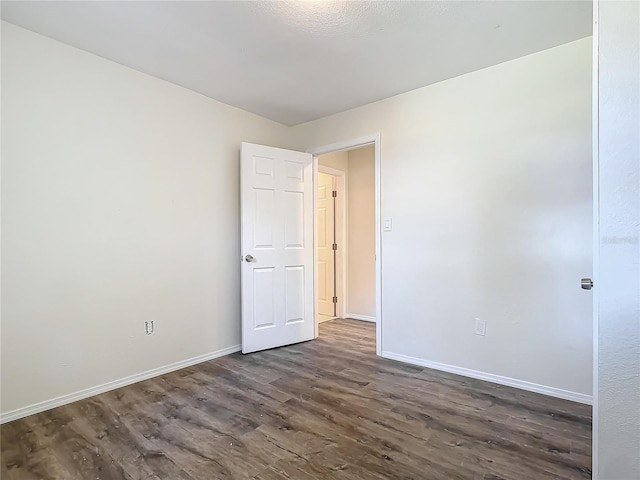 empty room with dark hardwood / wood-style floors