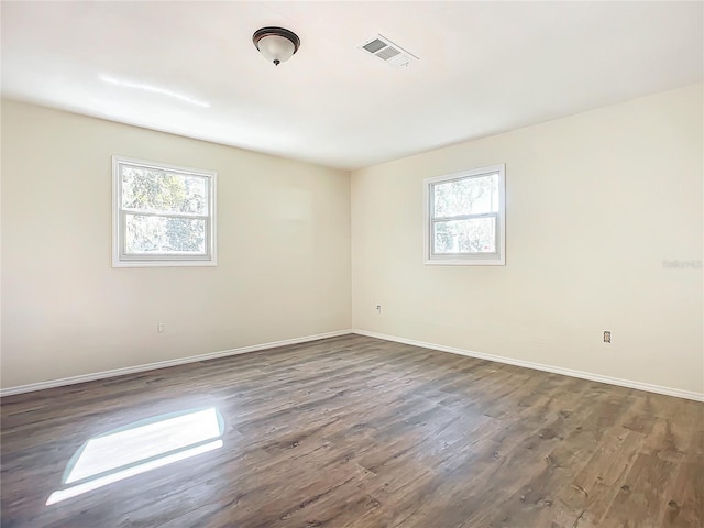 spare room featuring dark wood-type flooring