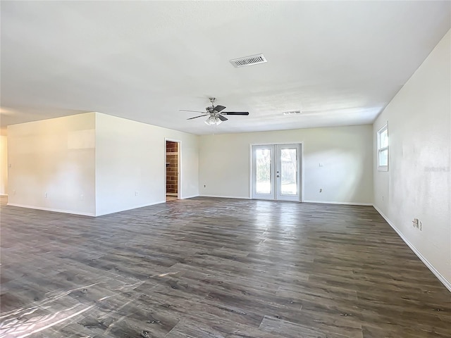 spare room featuring dark hardwood / wood-style flooring, ceiling fan, and french doors