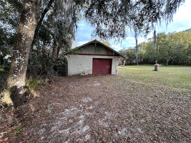 garage featuring a lawn