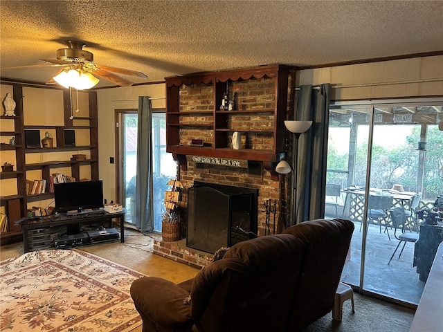 living room featuring a textured ceiling, ceiling fan, and a fireplace