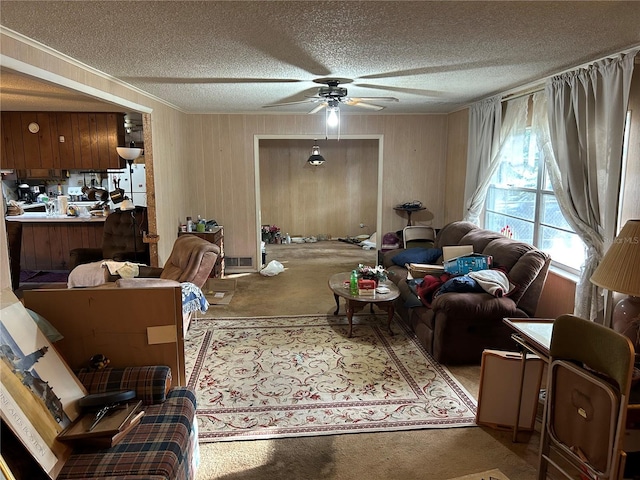 living room featuring a textured ceiling, ceiling fan, and wooden walls