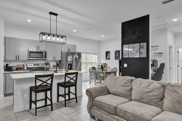 living room featuring light tile patterned floors and sink