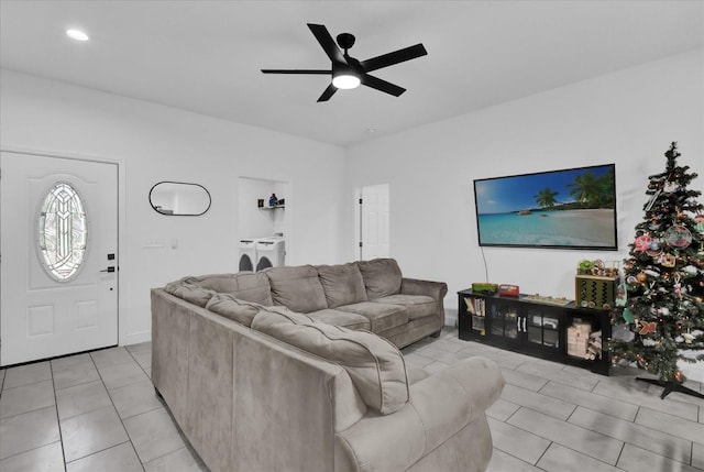 living room featuring washer / dryer, light tile patterned floors, and ceiling fan