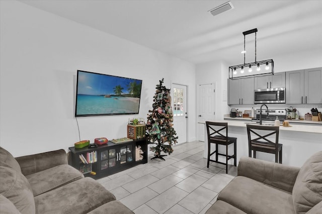 living room featuring light tile patterned flooring and sink