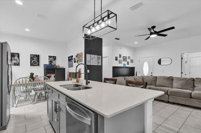 kitchen with ceiling fan, sink, pendant lighting, a kitchen island with sink, and appliances with stainless steel finishes