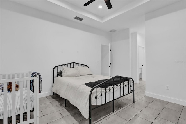 tiled bedroom featuring ceiling fan