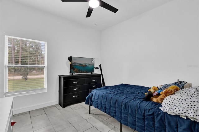 bedroom with ceiling fan and light tile patterned flooring