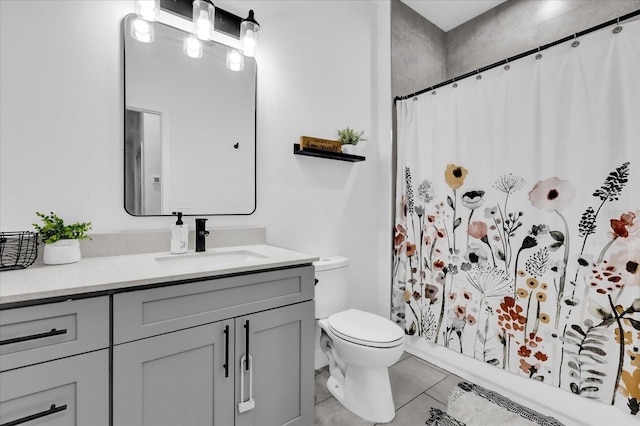 bathroom with tile patterned flooring, vanity, toilet, and walk in shower